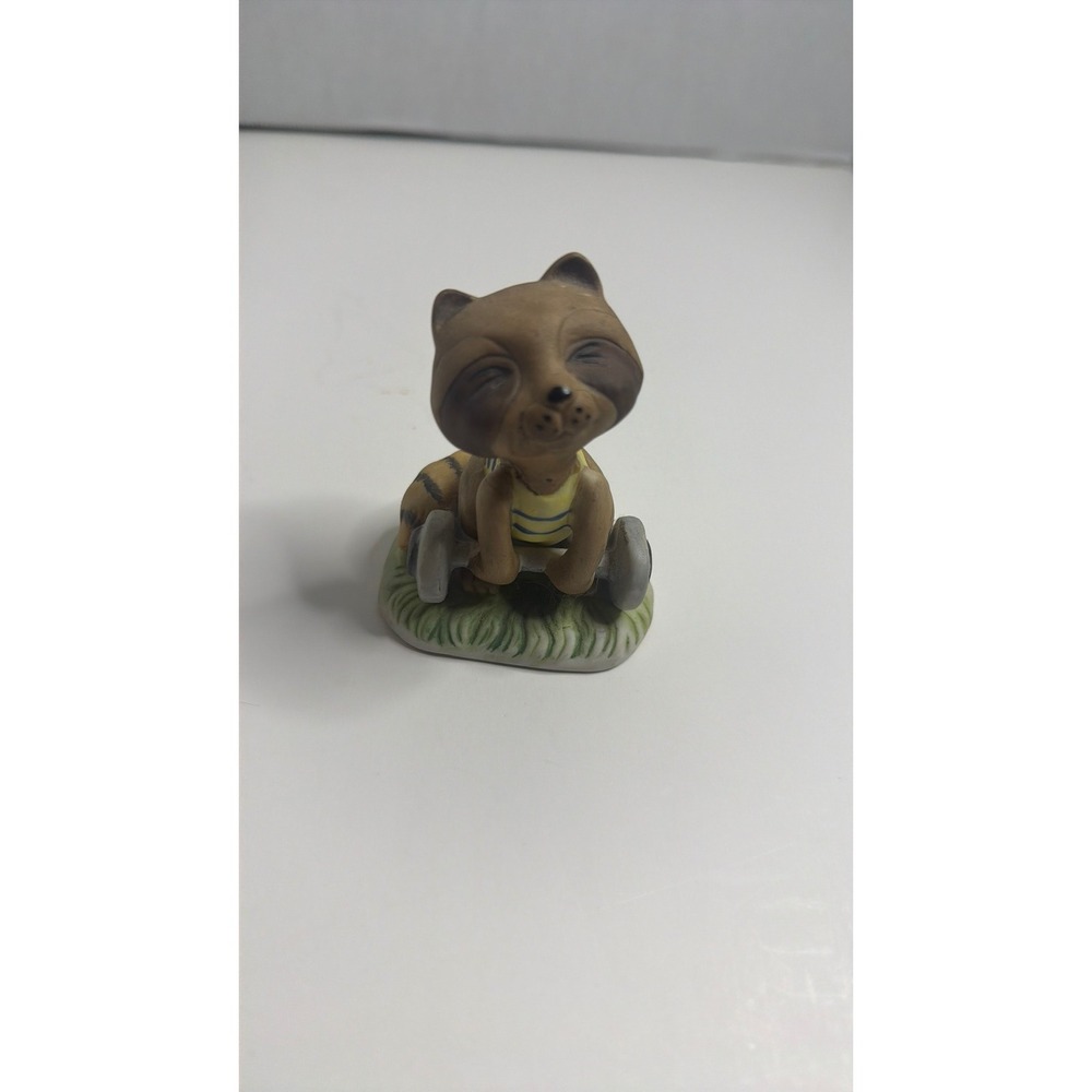 Ceramic Raccoon Figurine Sitting on Grass wi/Yellow Stripe Shirt Decor